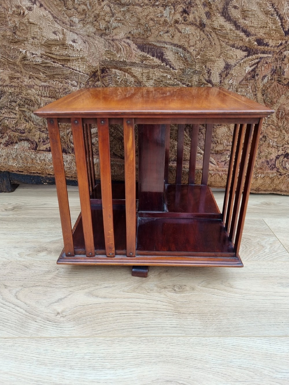 a satinwood banded mahogany table revolving bookcase