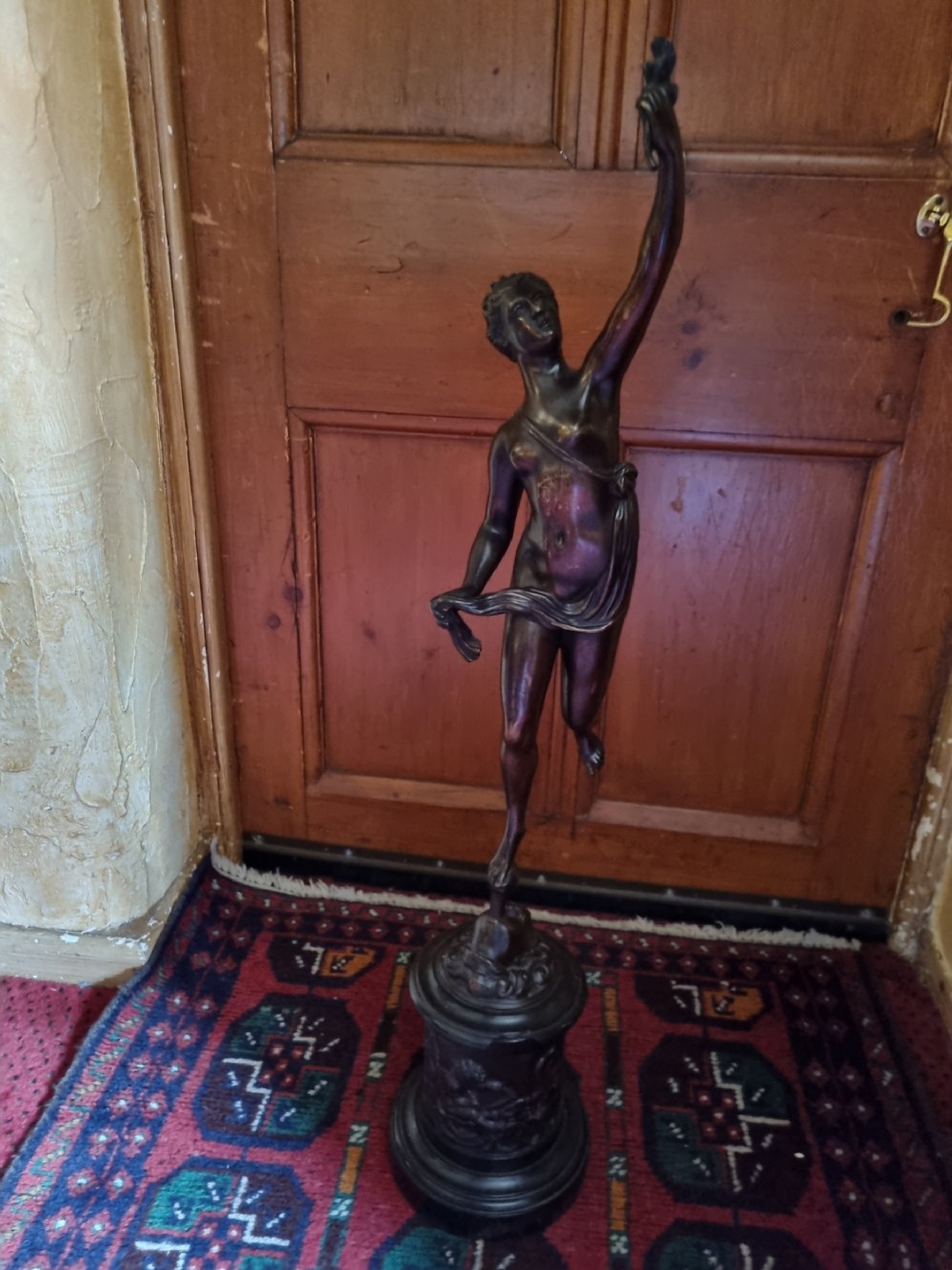 a large patinated bronze of fortuna on marble plinth